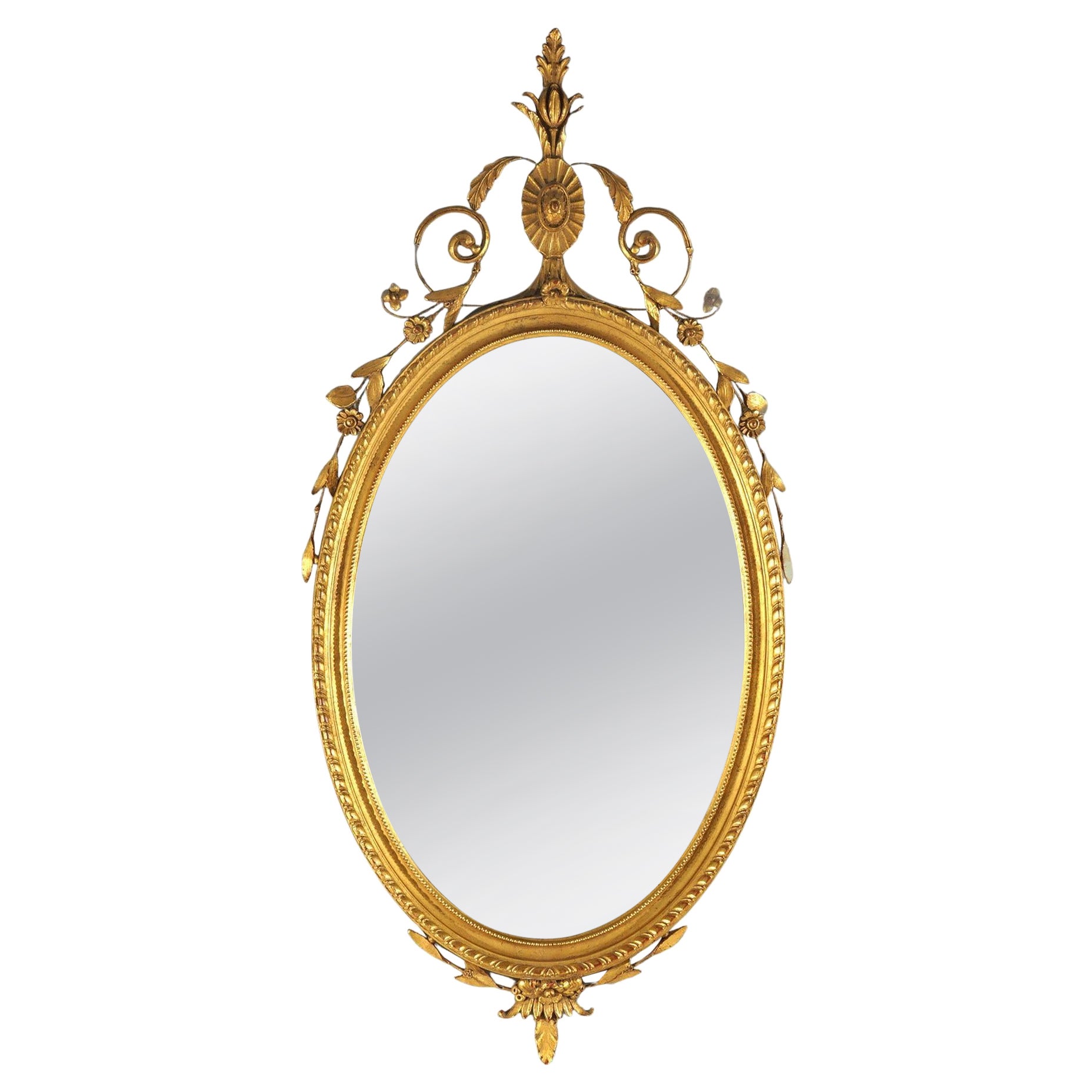 Grand miroir mural ovale en bois doré avec éléments floraux, feuillagés et volutes 20e siècle