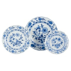 Meissen Blue Onion pattern. Three plates. Hand-painted with blue floral motifs.