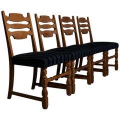 Four oak dining chairs in the style of Henning Kjærnulf, Denmark, 1960s