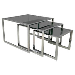 Italian modern Trio of coffee tables in smoked glass and metal, 1980s