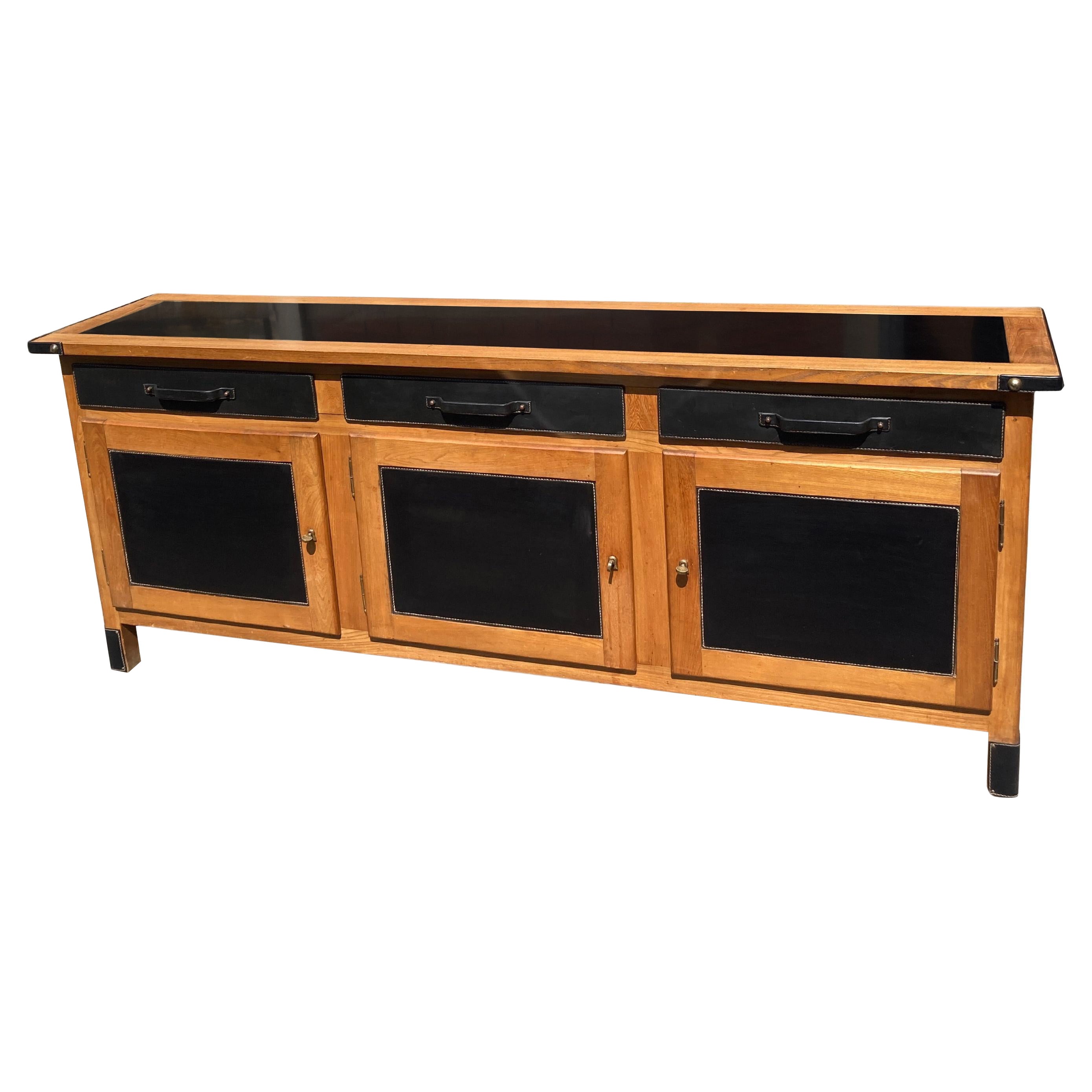 1950's Stitched leather and wood sideboard by Jacques Adnet