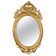 Specchiera Antica Ovale con Cimasa E Fiori, Dorata In Oro Zecchino, Epoca XIX.