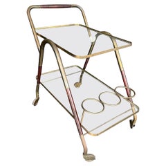 An Italian 1950s brass and lacquered wood bar trolley by Cesare Lacca