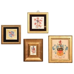 Collection of four framed coats of arms