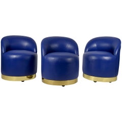 Karl Springer Style Chairs in Blue Leather with Brass Finish Base on Casters