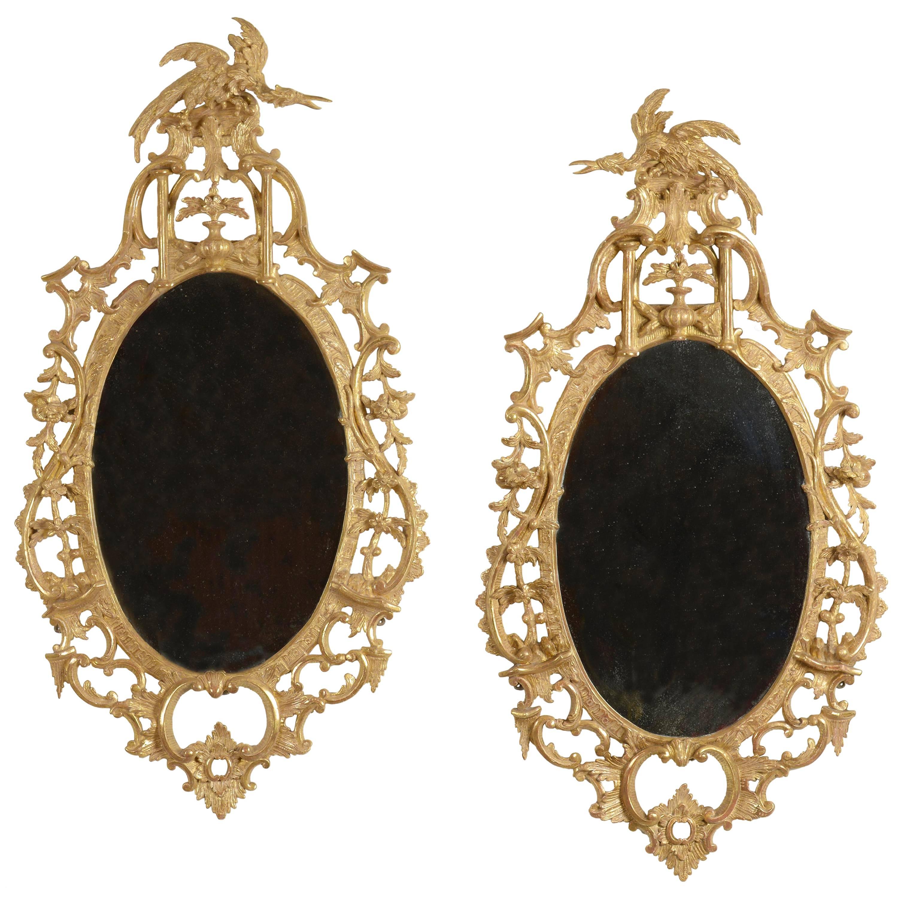 Pair of George III Carved Giltwood Oval Mirrors For Sale
