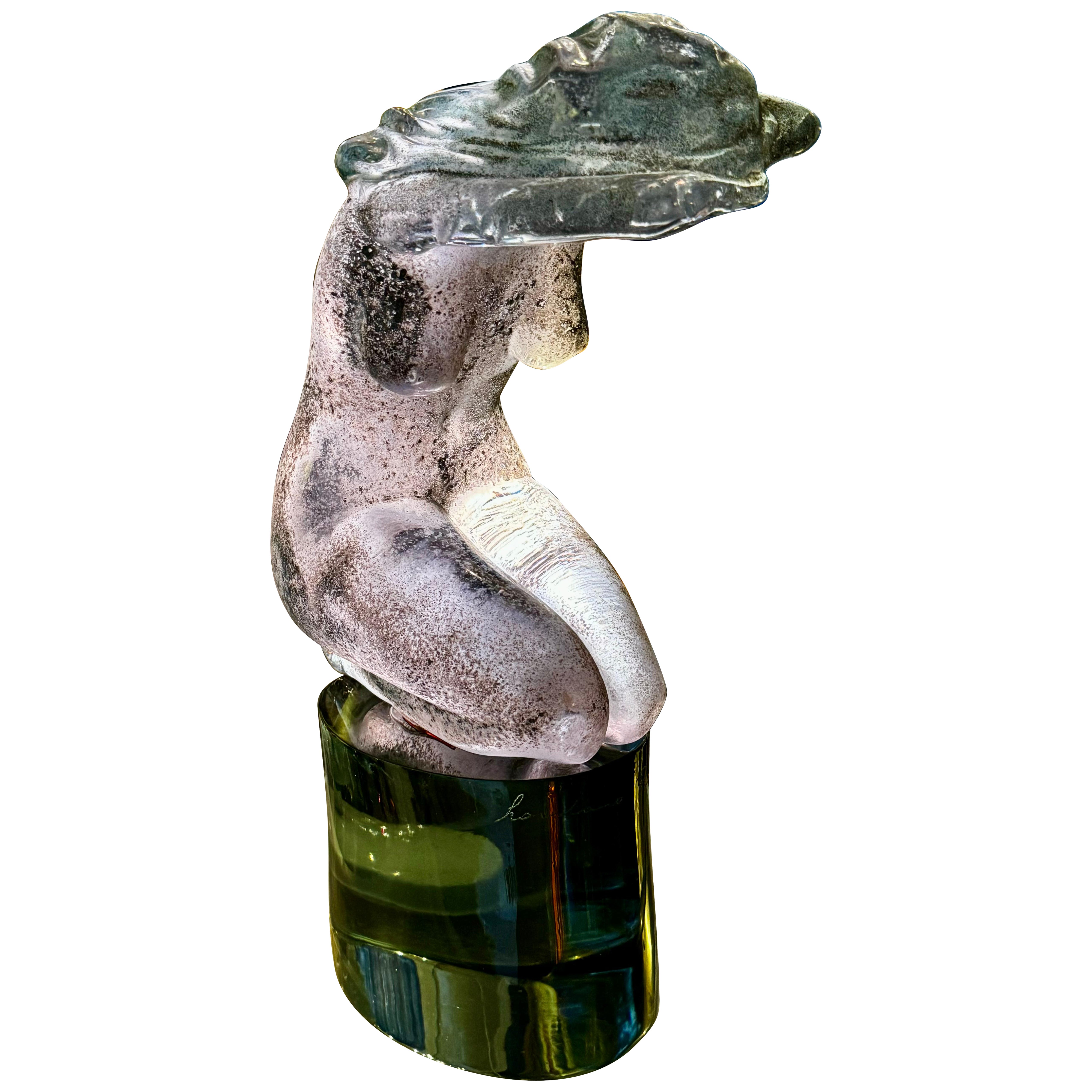 This exquisite piece of art captures the ethereal beauty of femininity through the unique lens of Loredano's craftsmanship. The glass figure, meticulously crafted in a rich alessandrite hue, shifts in color under different lighting, embodying the