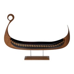 Sun, a cut steel blue glass & oak viking ship by Backhaus & Brown and Egeværk