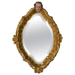 Specchio da parete in legno dorato in stile barocco francese con testa di cherubino