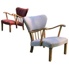 A pair of curved armchairs in solid oak from the 1940s.