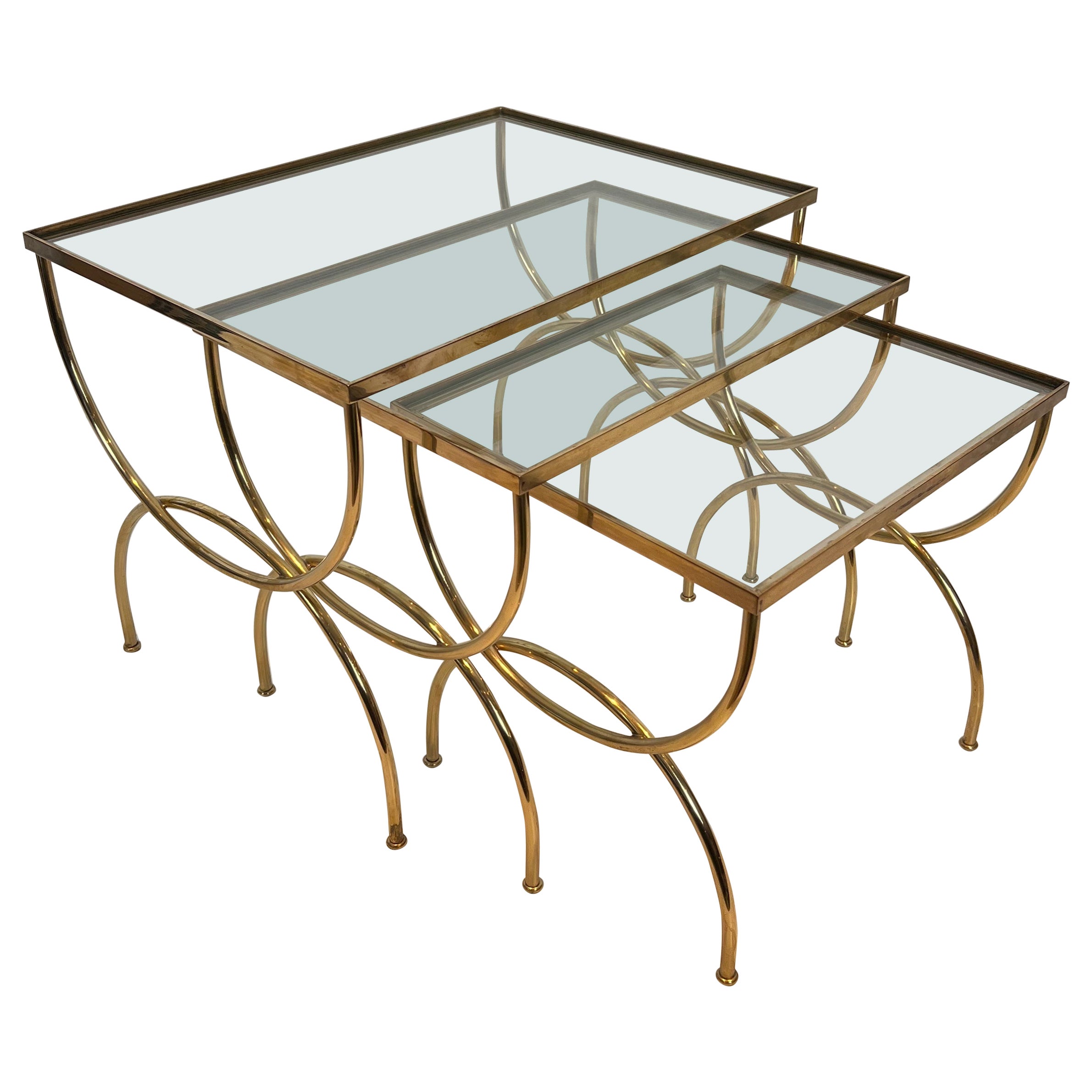 Neoclassical style brass nesting tables  with arcuate base. French work