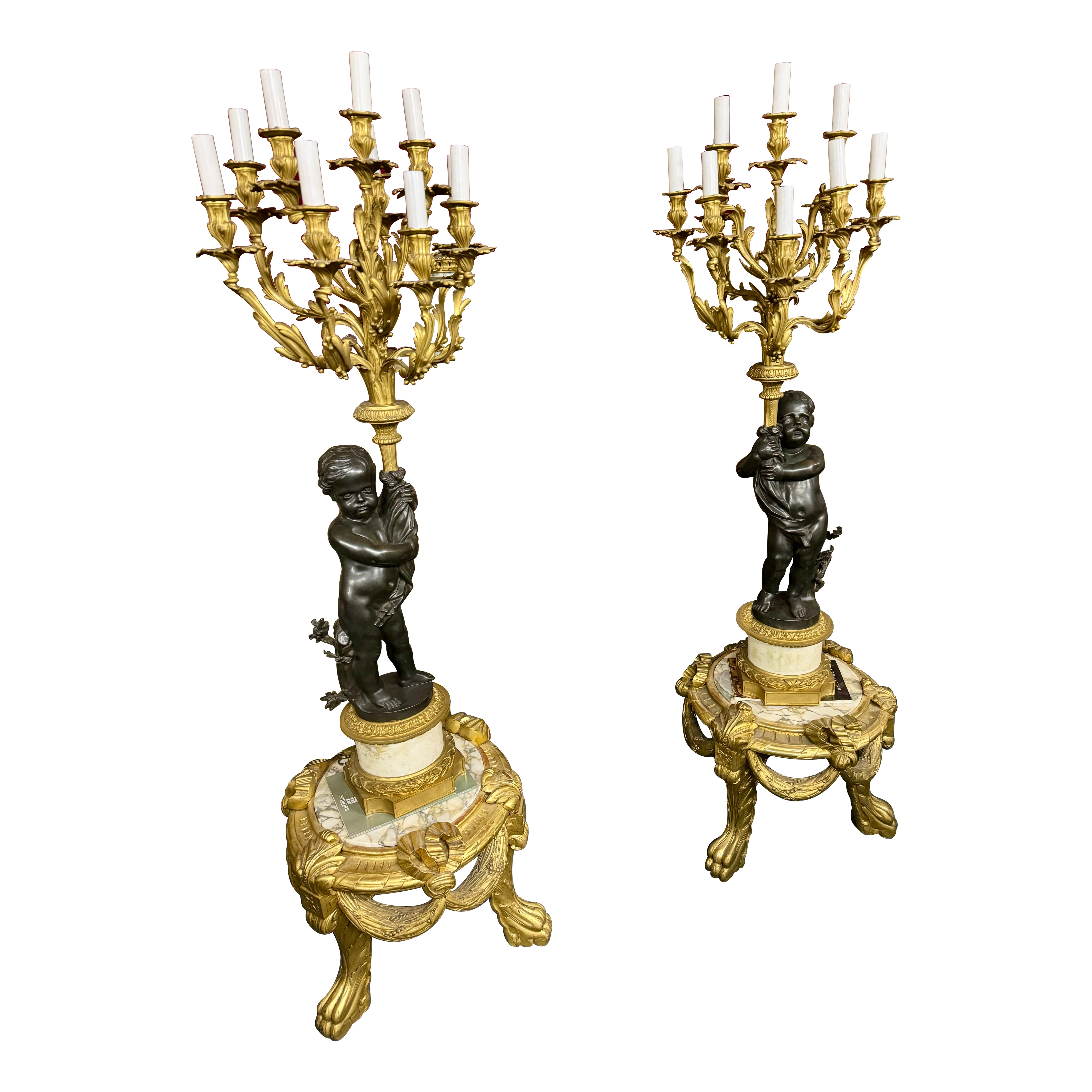 Huge pair of torcheres figurative bronze and marble representative cherub surmonted by candelabras nine lights, the base are in  giltwood and marble 
this set is of a very high  quality and very decorative
total height 71 inch
without the pedestal
