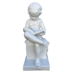 Italian White Porcelain Seated Putto Reading a Book