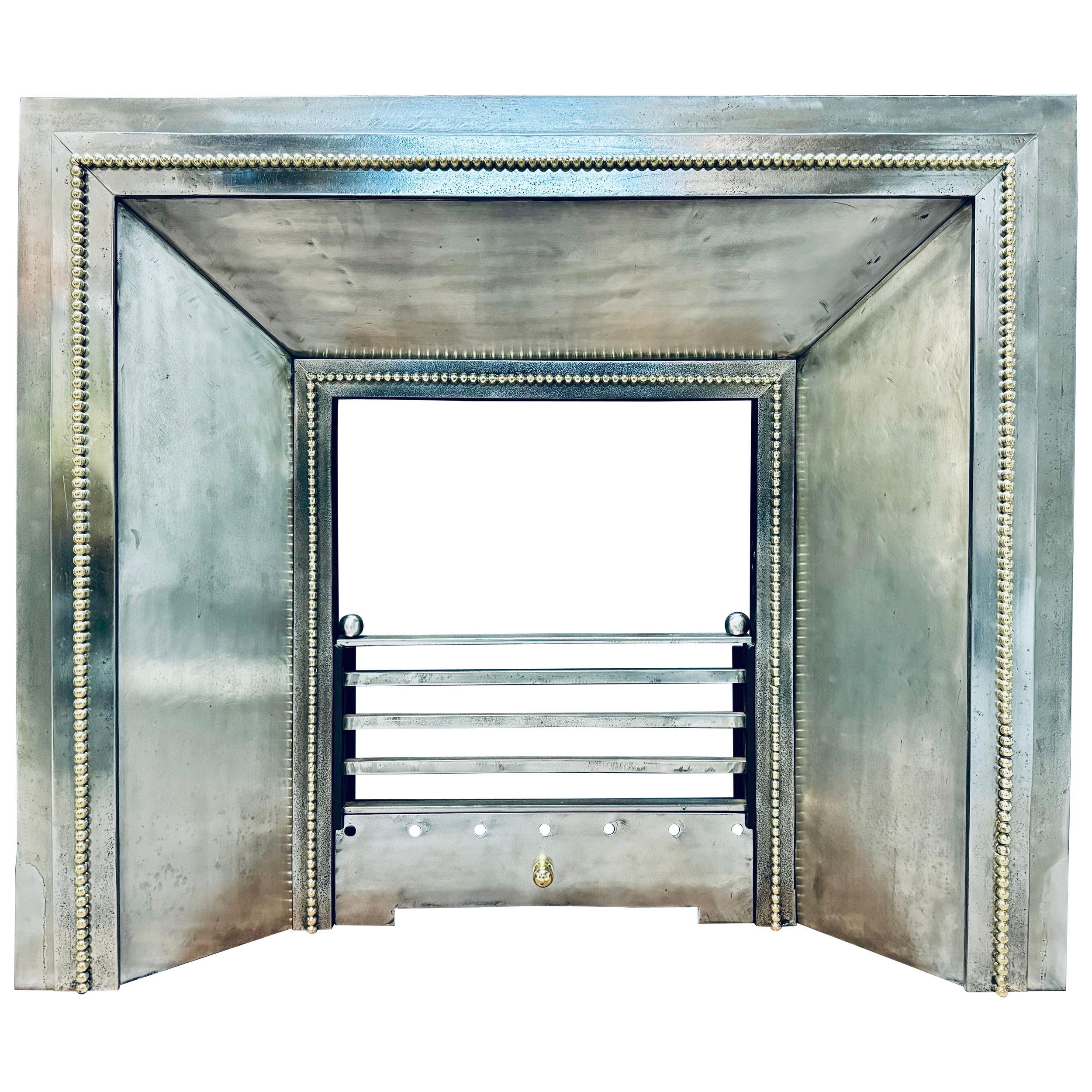 A Late 19th Century French Splayed Steel and Brass Fireplace Insert.