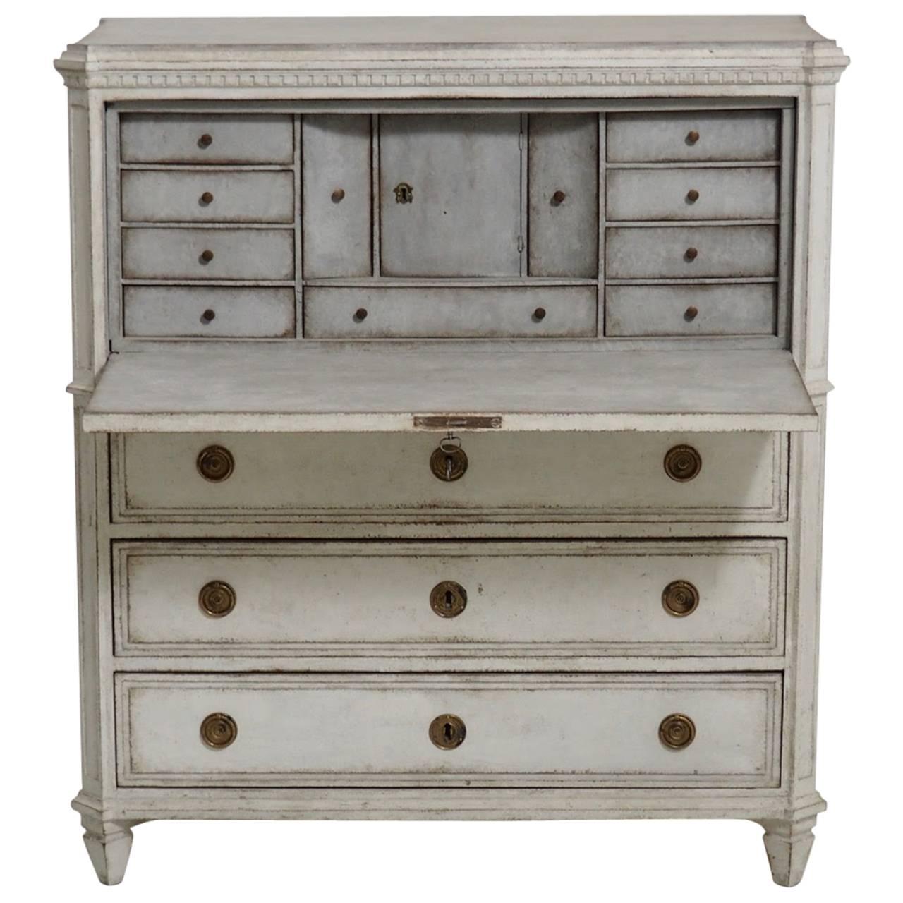 A beautiful Swedish fall-front secretary from the late Gustavian period with brass hardware and original locks and desk door key. This secretary displays neoclassical carving such as the dentil molding around the top, canted corners, and a reeded