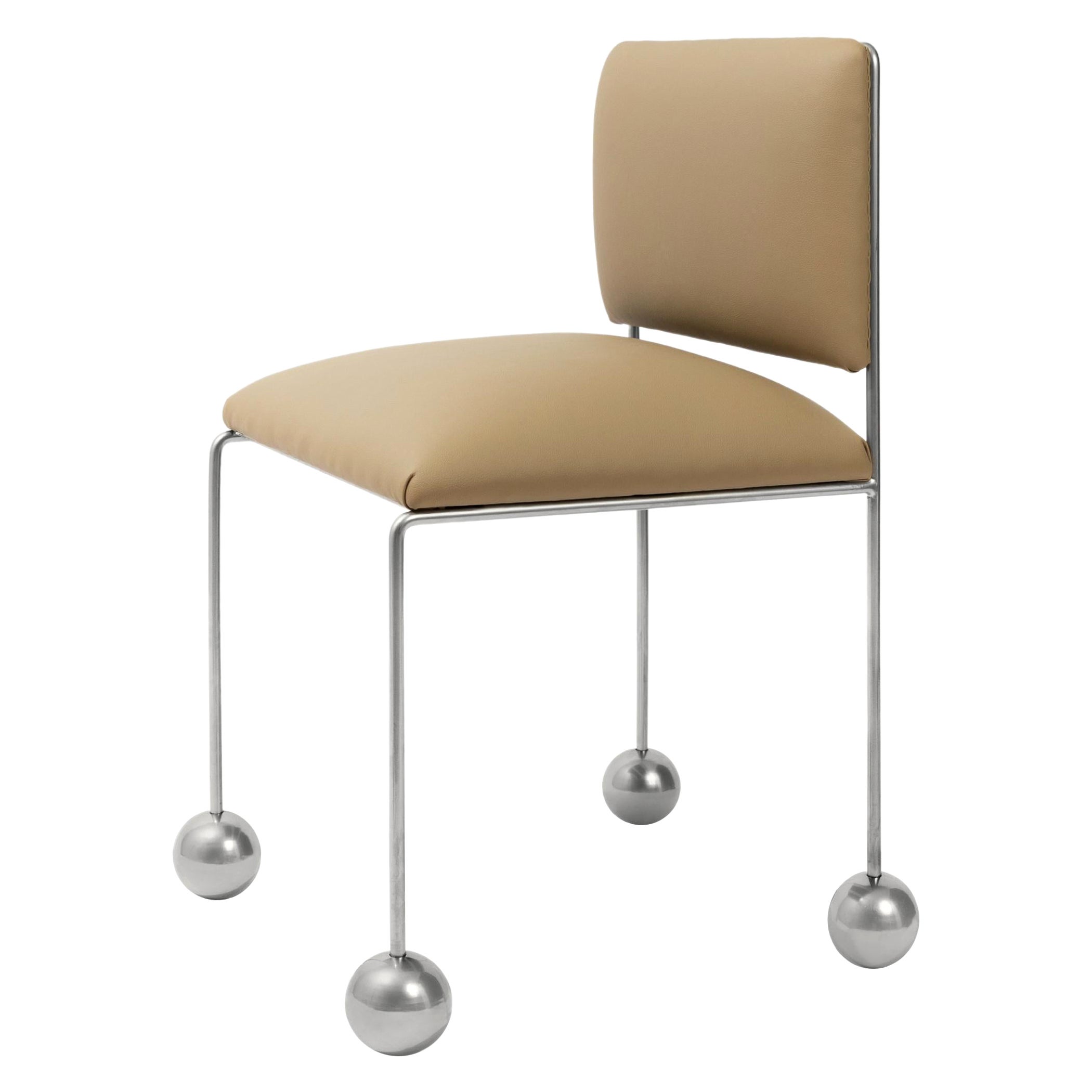The “Ball-Foot Chair” is upholstered with a subtle beige cactus leather, a vegan textile infused with natural cacti fibers, which is produced in Mexico. The chair’s comfortable and rounded seat is playfully in dialogue with its distinctive spherical