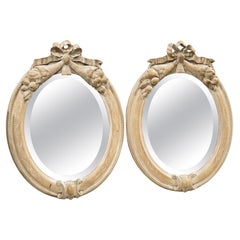 Pair of French Louis XVI Carved and Whitewashed Wooden Oval Mirrors, Early 1900s