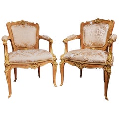 A pair of F. Linke designed 20th c French gilt bronze mounted armchairs