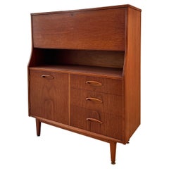 A mid century modern cabinet with a drop front desk by Jentique furniture