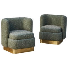 Armchairs with brass base by Studio Glustin
