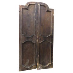 Antique Walnut wood door arched, two leaves with carved panels, Italy