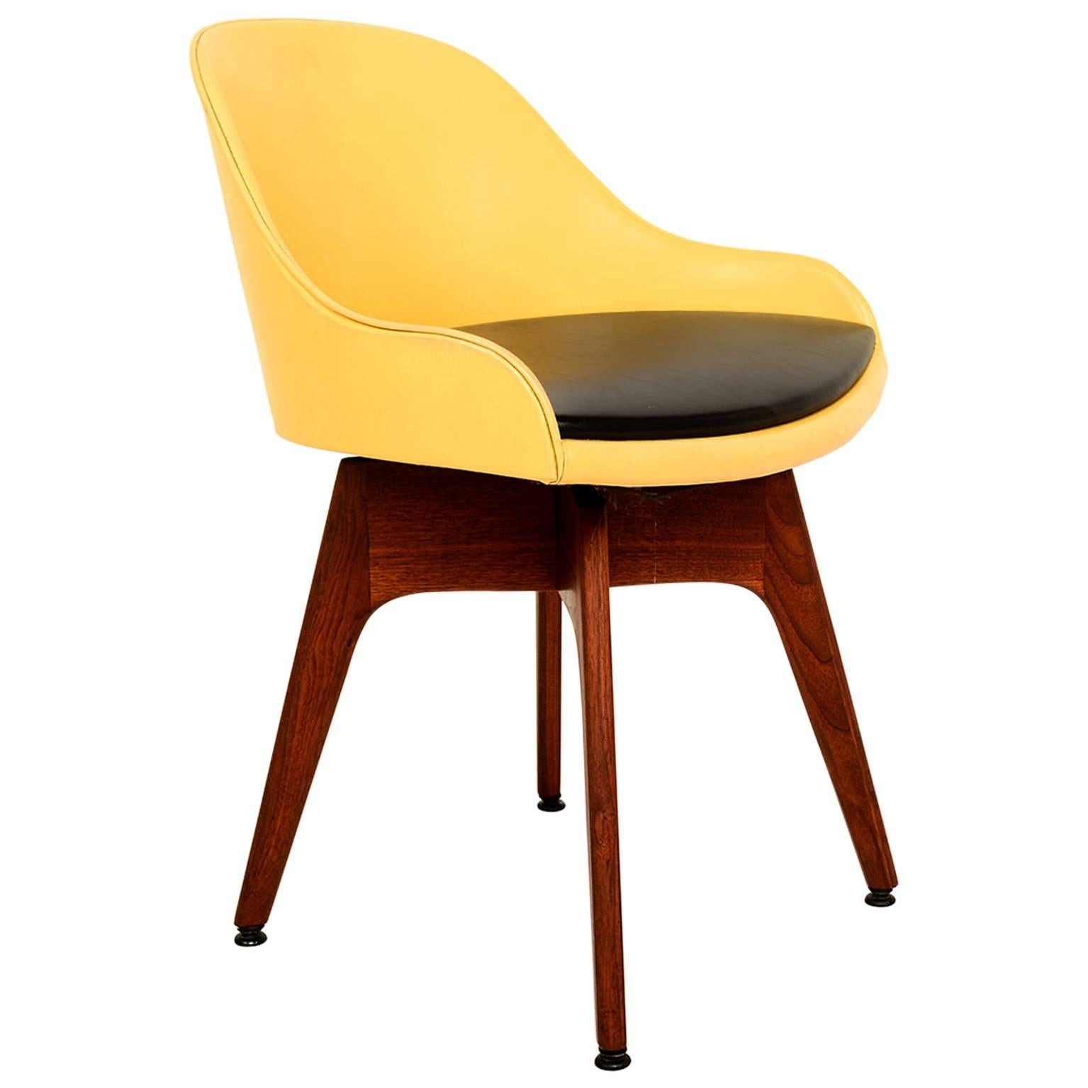 Mod Side Chair USA 1960s the style of Edward Wormley for Dunbar Furniture
Constructed in solid walnut wood.
Original upholstery in yellow and black leatherette
Chair has a fun swivel base. 
 28H x 20.5 W x20 D, Seat 18 H 
Unmarked no label or