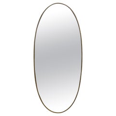 Specchio ovale anni '50 con cornice in ottone