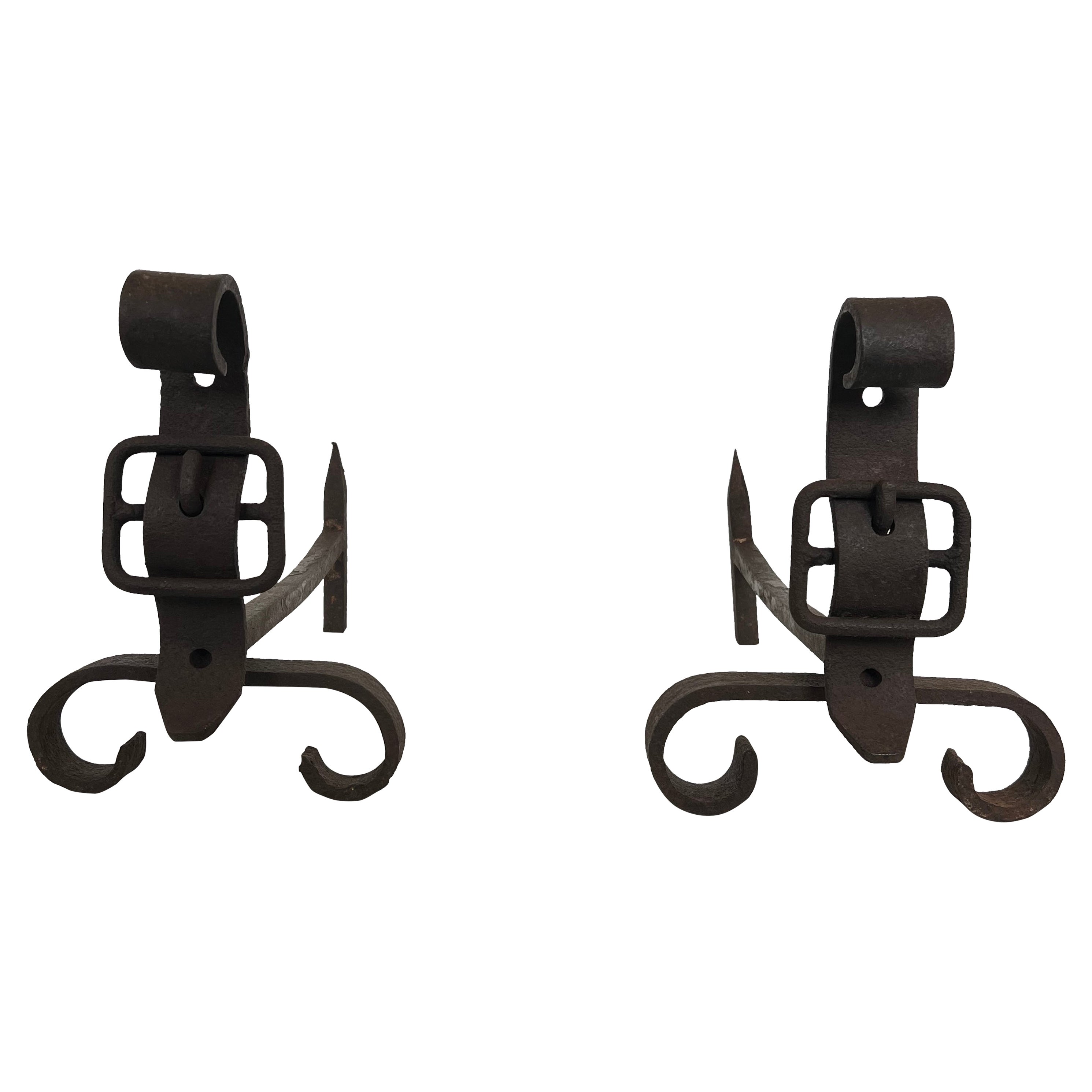Pair of cast iron and wrought iron andirons representing a belt. French work. For Sale