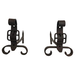 Pair of cast iron and wrought iron andirons representing a belt. French work.