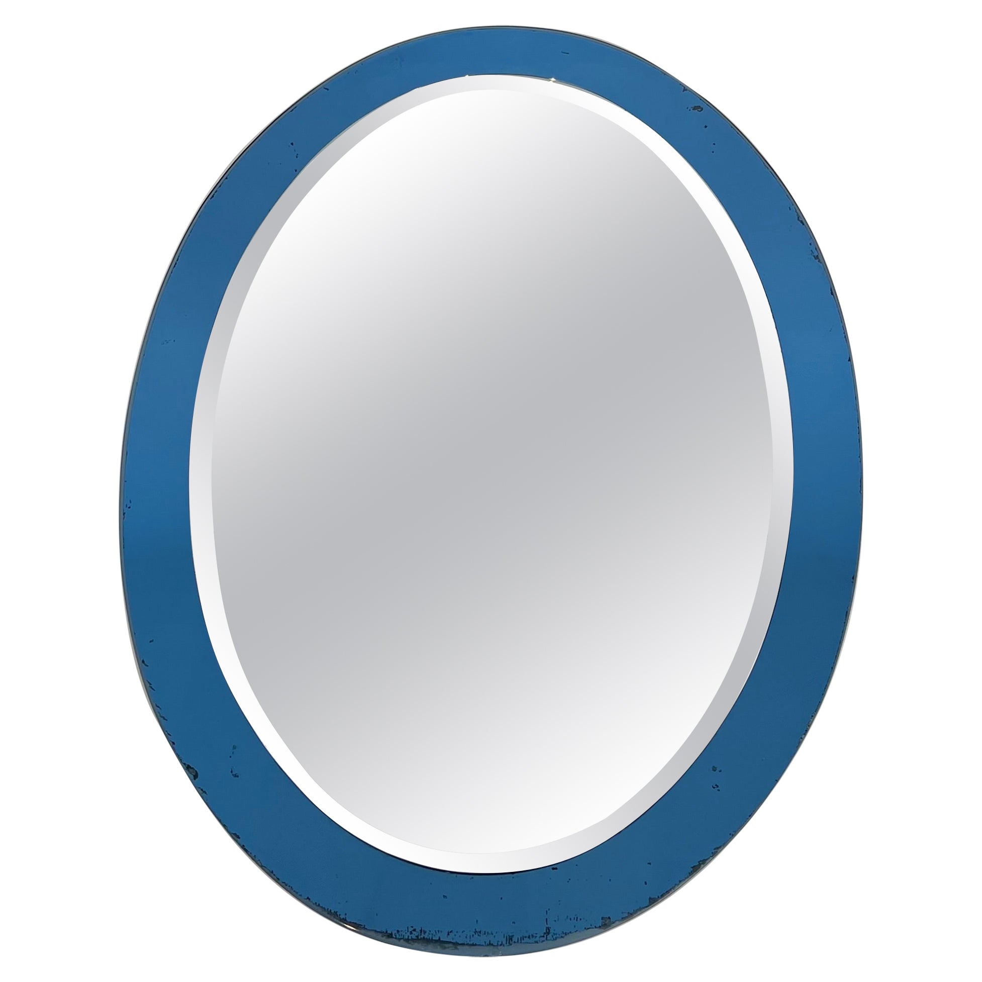 Oval-Shaped Mirror with a Bluish Surround by Crystal Art Torino. Circa 1960
