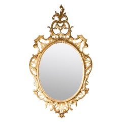 Miroir ovale en bois doré de style rococo du début du 19e siècle