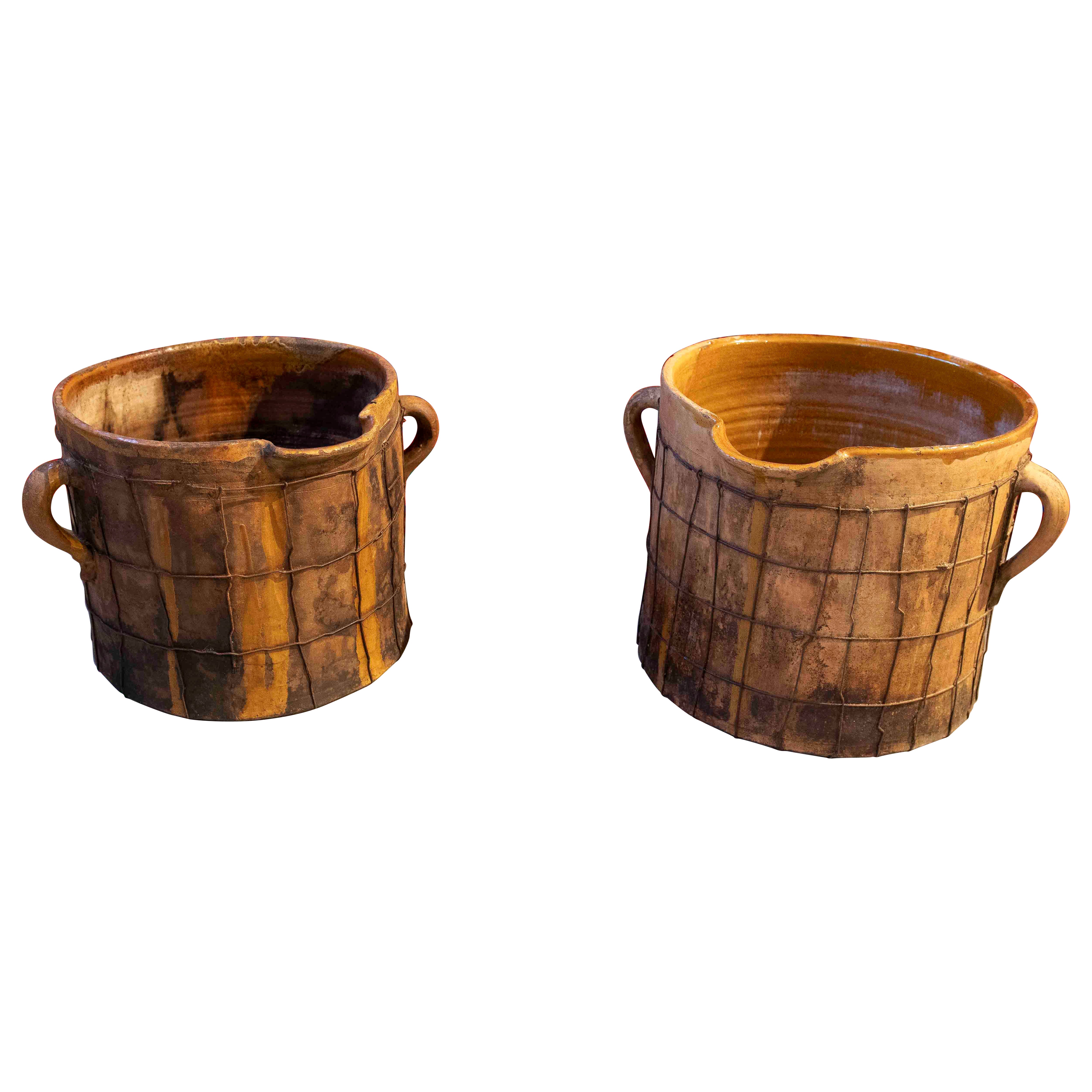Pair of Enameled Ceramic Milk Churns with Handles & Iron Netting Covering Them For Sale