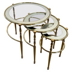 Set of 3 round brass nesting tables with glass tops surrounded with silver rims