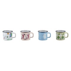 Muurla, Finland. Four enamel mugs with motifs from the Moomintroll stories
