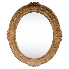 Grande specchio ovale in quercia intagliata e dorata, periodo Luigi XV, XVIII secolo