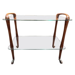 A 1950s Italian curved walnut & glass bar cart