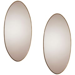 A pair of oval brass mirrors, Italy, 1960s