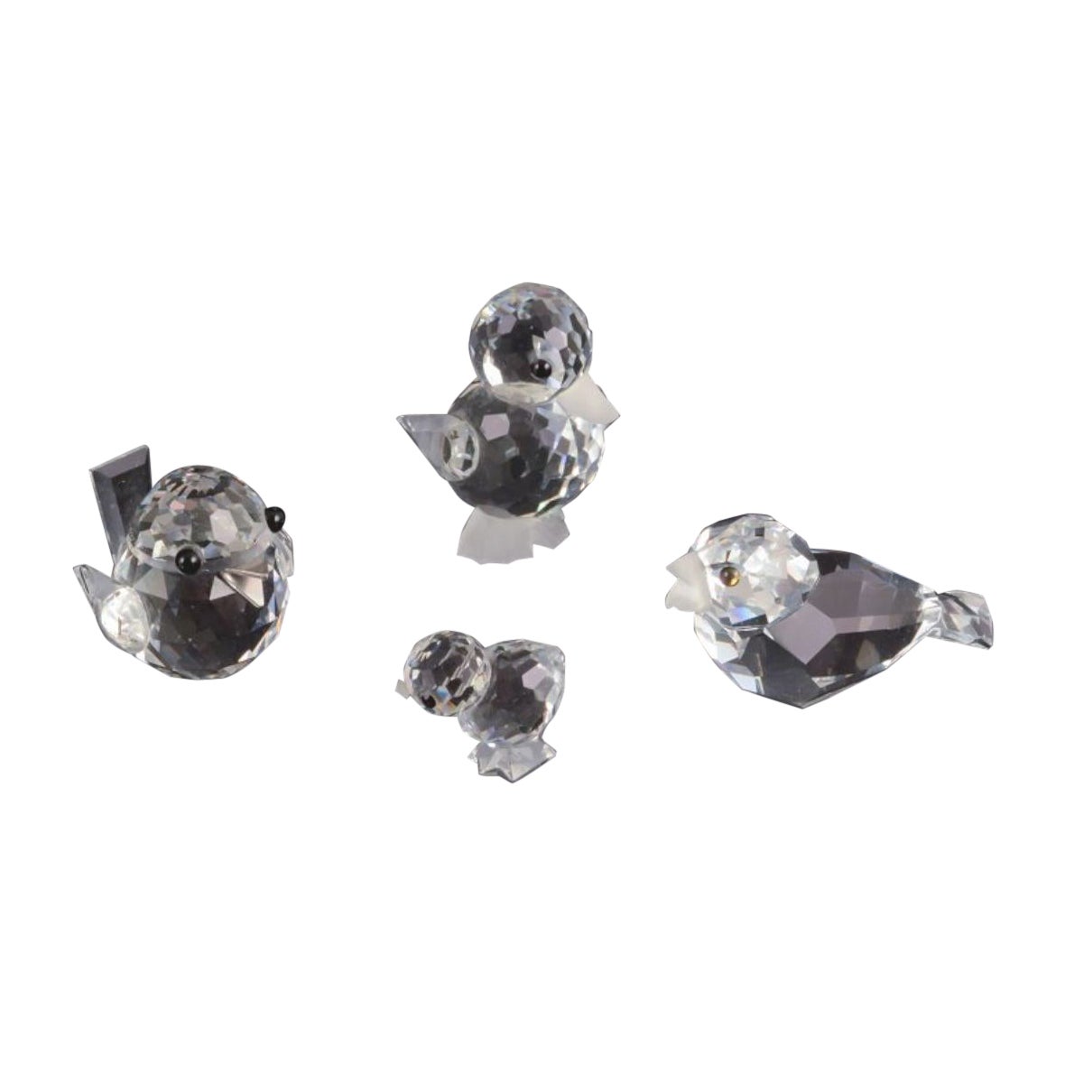 Swarovski, Austria. Four miniature bird figurines in faceted cut crystal glass.