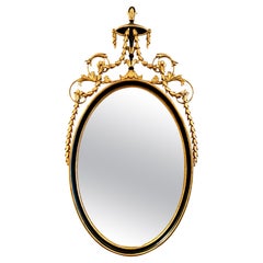Miroir ovale en bois doré noir et sculpté de style néoclassique Fabriqué en Italie