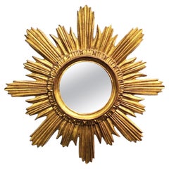 Miroir mural italien à étoiles ensoleillées, cadre doré, circa 1970.