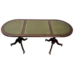 Wooden coffee table with bronze claw feet and green leather on Top