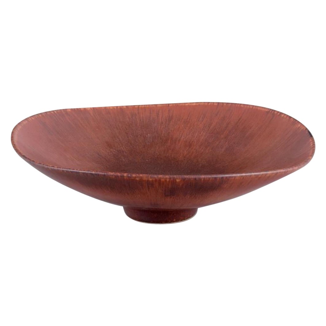 Carl Harry Stålhane for Rörstrand. Large ceramic bowl with glaze in brown tones.