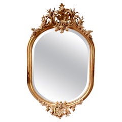 Antique French Carved Gold Leaf Wood and Beveled Oval Mirror, Circa 1890.