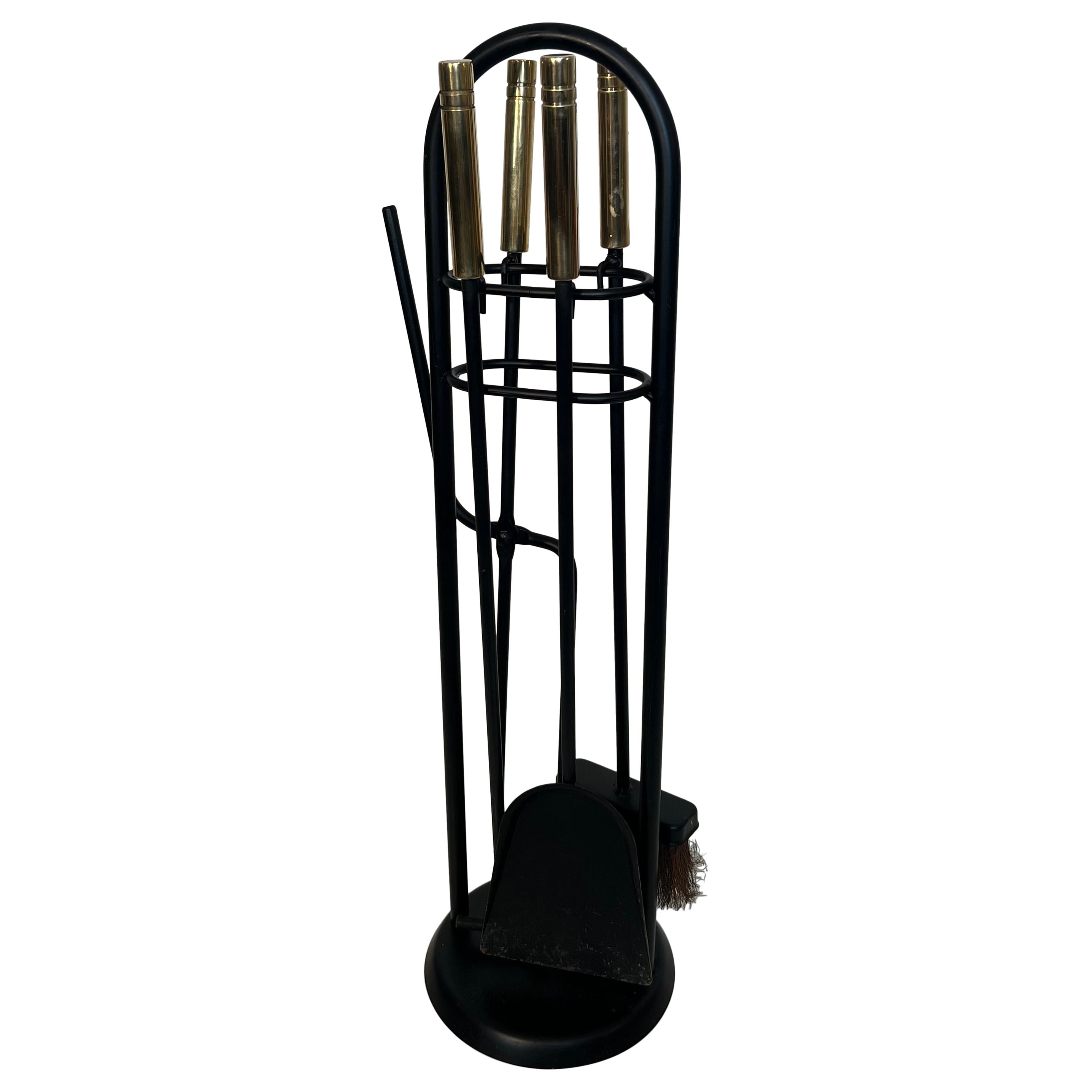 Herramientas para chimenea en soporte de metal lacado negro y diseño de latón