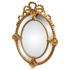 Gran espejo de pared oval dorado del siglo XIX