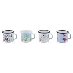 Muurla, Finland. Four enamel mugs with motifs from the Moomin stories
