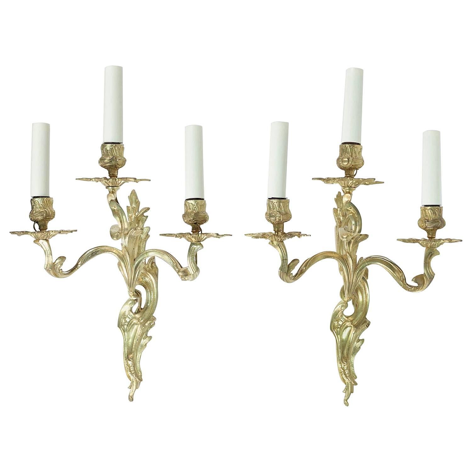 Pair of Louis XV Style Three Armed Sconces in Gold Gilt Bronze