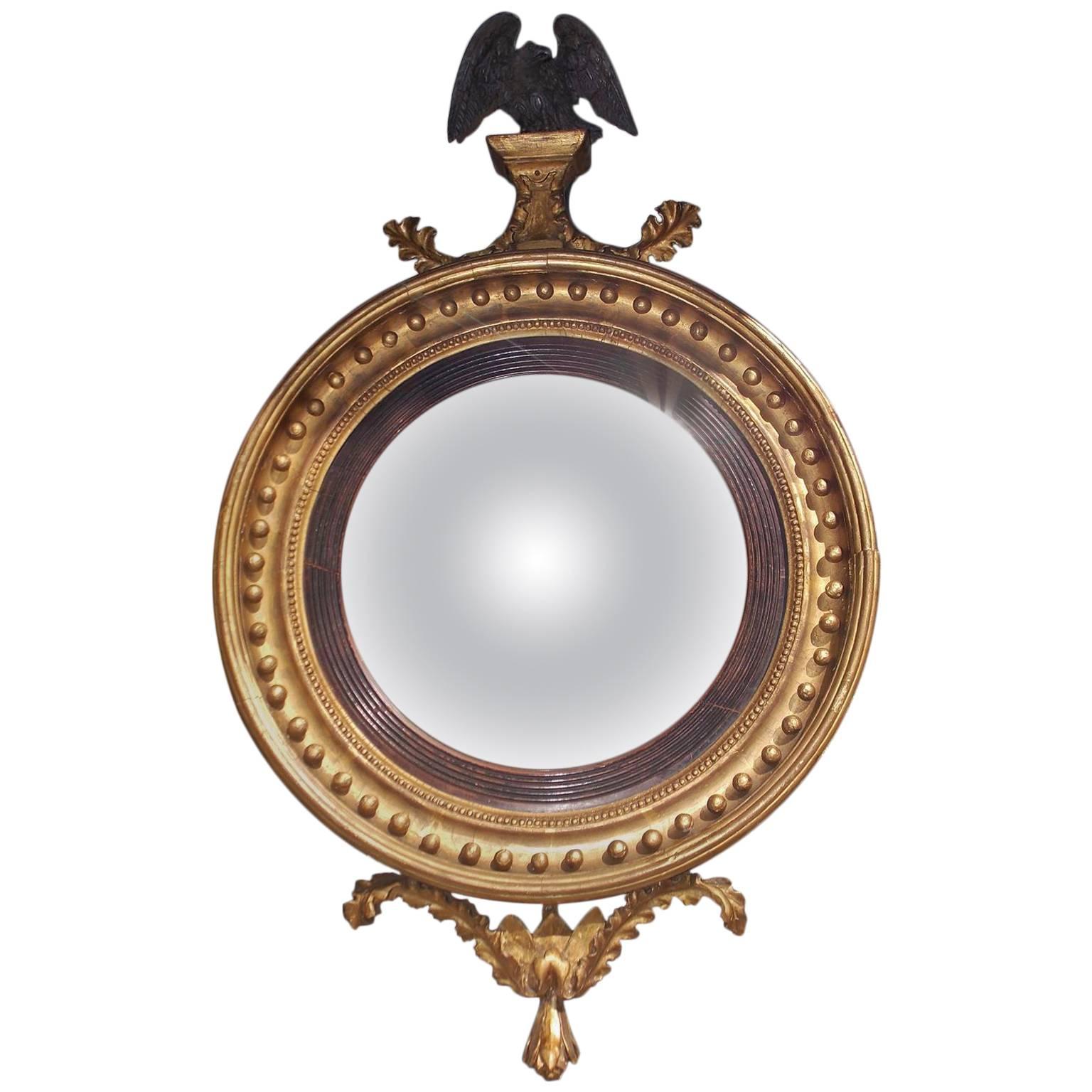 English Gilt Convex Mirror with Ebonized Perched Eagle, Circa 1810 For Sale