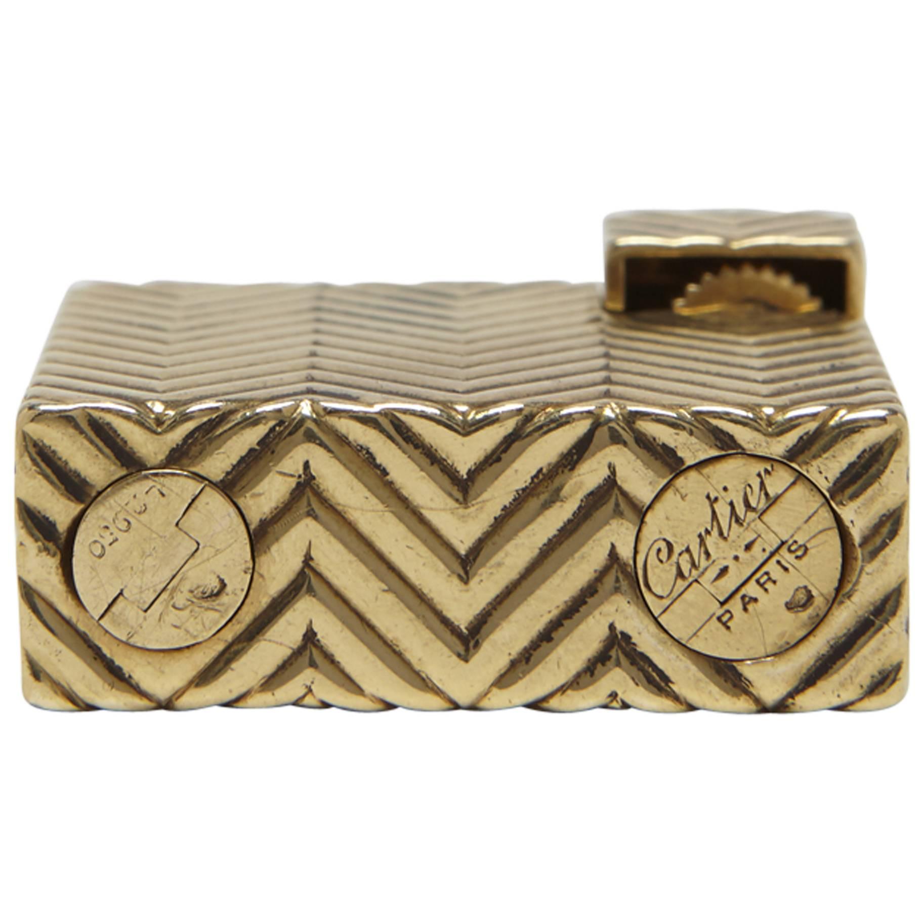 A very rare Cartier Art Deco solid 18-carat gold petrol wick lighter. This is the smaller size model of Cartier's pocket lighter collection. The body of the lighter is fully covered in a herringbone pattern which masterfully continues throughout all