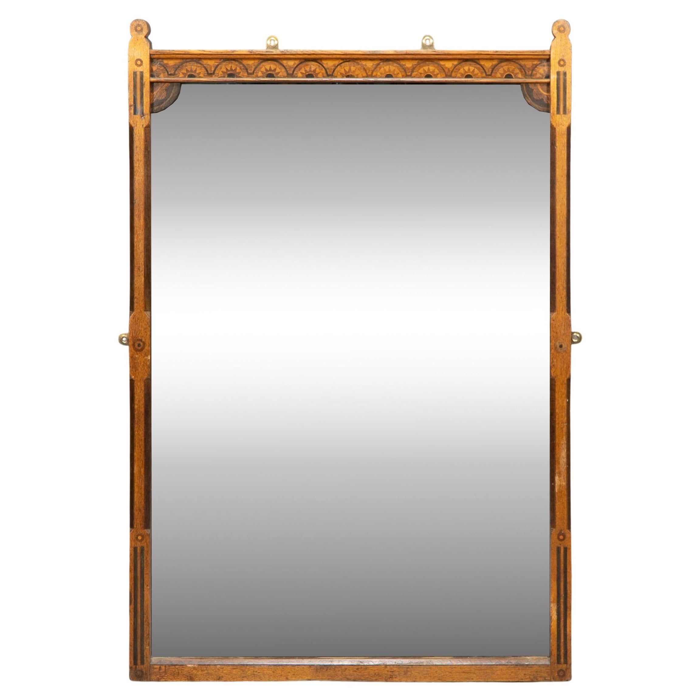 Charles Bevan style of. A Gothic Revival oak wall mirror